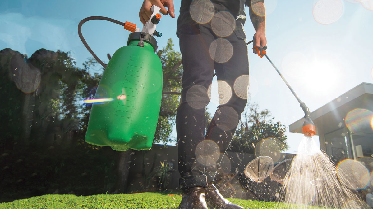 Genius Gardening Gifts Ezyspray 5L tank being used to spray wetting agent on lawn
