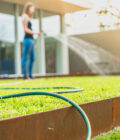 Hand watering the lawn in summer