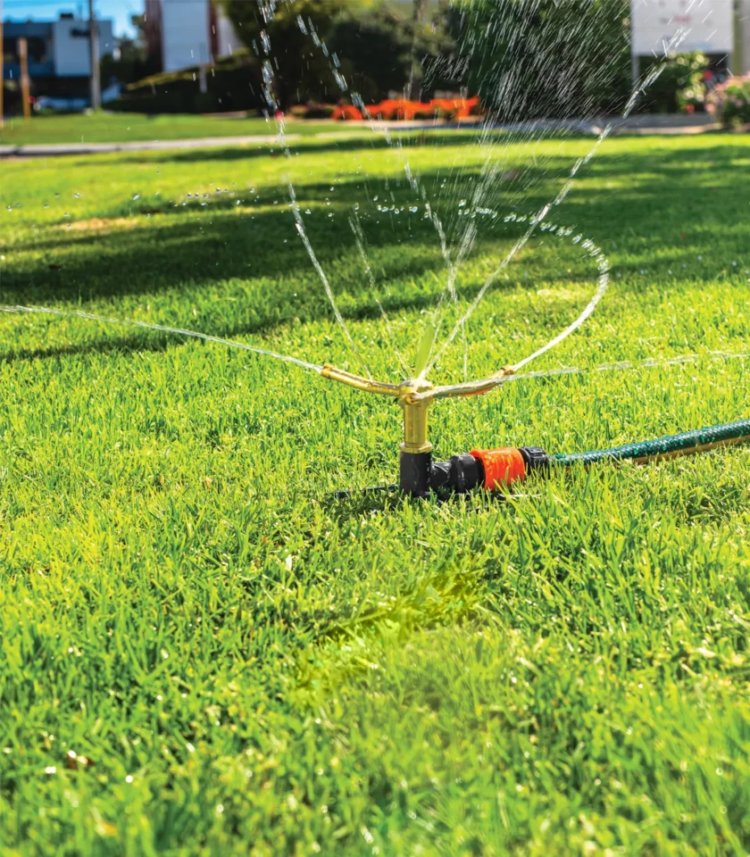 3 Arm Metal Sprinkler watering lawn 3 Arm Metal Sprinkler watering lawn